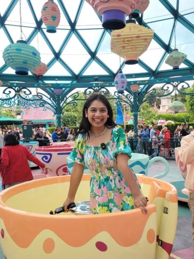 Traveler Jyoti sitting in a spinning teacup ride at Disneyland Paris