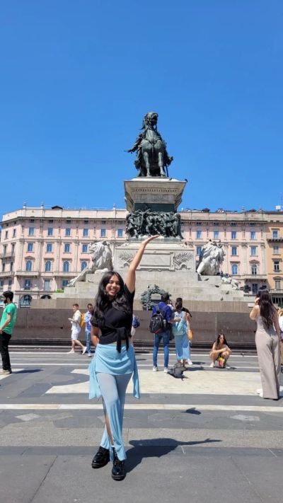 Traveler Jyoti in Piazza del Duomo in front of the Vittorio Emanuele II monument, Milan