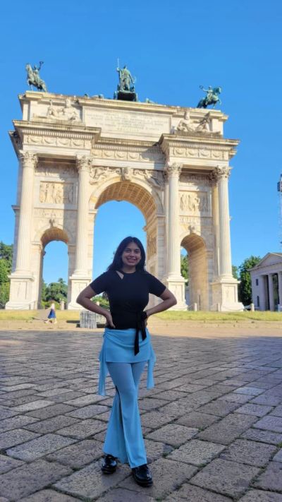Traveler Jyoti standing in front of the Arco della Pace (Arch of Peace) at the end of Parco Sempione in Milan