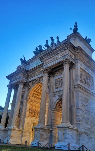 The Arco della Pace (Arch of Peace) in Milan lit up gold in the evening