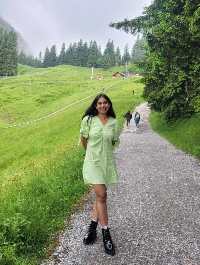 Traveler Jyoti walking up the gravel path toward the Kriens cable car station for Mount Pilatus