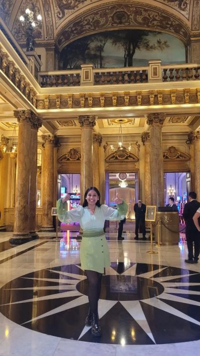 Traveler Jyoti inside the grand marble and gold Atrium of the Casino de Monte-Carlo in Monaco