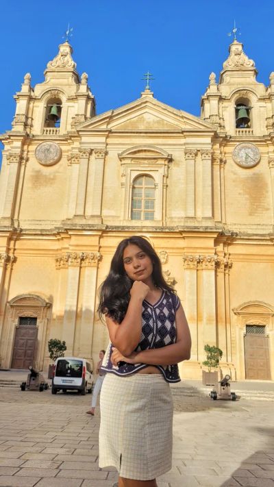 Traveler Jyoti in front of St Paul's Cathedral in Mdina, Malta